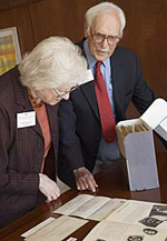 Actor and Alumnus Harold Gould and his wife, Lea, peruse some of Gould's photos and personal papers, which were among more than 10,000 documents - including scripts, programs and news clippings - donated by Gould to the University at Albany's Libraries.