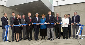 President Kermit L. Hall and group in a symbolic ribbon-cutting for the new UAlbany facility.