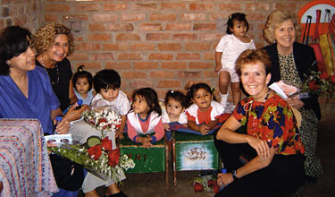 From left, Blanca Ramos, Bonnie Carlson, Mary McCarthy, and School of Social Welfare Dean Katharine Briar-Lawson with children at a daycare center in Peru.