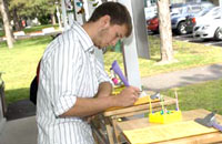 Student in front of the Office of Parking &amp; Mass Transit Services