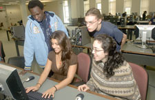Philip Ayoreh and Tom Keegan work with Kristina Zaccardo and Elise Martin in the new Information Commons in the Science Library.
