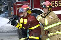 Michael Rothschild and Joseph Zambon carry out a fire hose drill