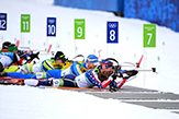 Olympic althetes are shown competing in a Biathlon. 
