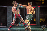 Two mixed martial arts fighters battle it out at the Cage Wars 35 event. 