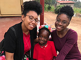 Students Jenee and Elizabeth with Ugandan boy