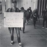 Student with sign at Perkins Loan rally