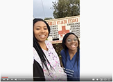 Screenshot of two graduate students (looking at camera) outside the Engeye Health Clinic in Mbarara, Uganda.
