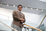 Photo of Nilanjan Sen standing on staircase in the School of Business.