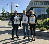 MBA students Tim Ellis, Gary Pierce and Ema Buco stand outside the School of Business. 