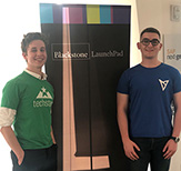 Photo of Noah Beadle and Bailey Ryan posing in front of Blackstone LaunchPad sign 