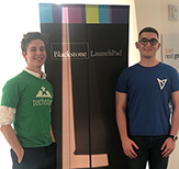 Photo of Noah Beadle and Bailey Ryan posing in front of Blackstone LaunchPad sign 