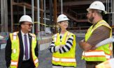 President Havidán Rodríguez and SUNY Chancellor Kristina M. Johnson, wearing safety vests and hardhats, talk to a similarly clad man at the ETEC site