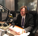 Photo of David Holtgrave recording his Academic Minute episode in WAMC's studio. 
