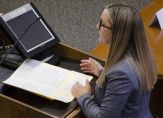 student Carlyanne Cicero stands in front of a podium with her notes at the moot court competition.