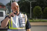 Stephen Conard, in an emergency vest, speaks into a two-way radio