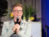 YouTube star Tyler Oakley speaks into a microphone.