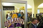 Photo from the Blackstone LaunchPad's opening in 2016. Pictured: Crowd congregates/socializes with one another outside of the door where the program is located in the Campus Center. 