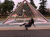 Student poses in front of fountain in the Park of the Exposition in Lima, Peru. 