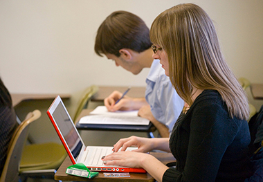 Girl at UAlbany sits in front of computer