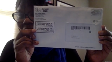 Dafney Amilcar-Rodriguez, UAlbany bursar and president of the Omicron Epsilon Zeta (Capital Region) Chapter of the century-old Zeta Phi Beta sorority, holds up a U.S. Census envelope during the webinar promoting voting and filling out of the Census.
