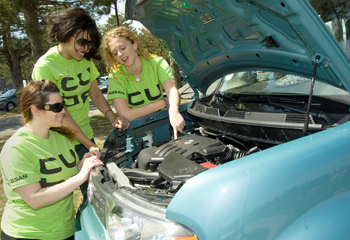 UAlbany students look under the hood of a Nissan cube car.