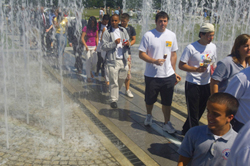 UAlbany students walk through the spray of the fountains at the new Entry Plaza.