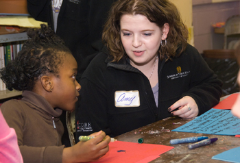 SPH student and a girl from the Boys and Girls Club working together.