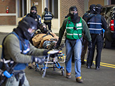 First responders carry a man on stretcher during active shooter training at the New York State Preparedness Training Center in Oriskany, N.Y.