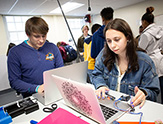 UAlbany students Ian Jaffe and Kristen Kespert display their projects inside the CEHC Makerspace.