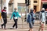 People wearing masks while crossing the street due to COVID-19.