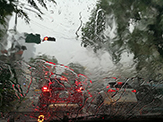 Photo of precipitation on car windshield from heavy rain storm.