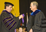 UAlbany President George Philip bestows the Collins medallion on Lindsay Childs at the 2009 Winter Commencement. 