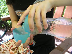 Cold water poured from a plastic water bottle