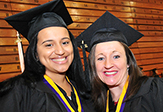 Two graduates at commencement