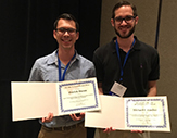 DAES graduate students Patrick Duran and Michael Fischer hold their awards at the American Meteorological Society Hurricane and Tropical Meteorology Conference.