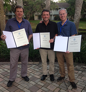 DAES department chair Chris Thorncroft, along with DAES graduate Jason Dunion ’15 and Chris Velden of the University of Wisconsin-Madison, hold the Banner I. Miller award