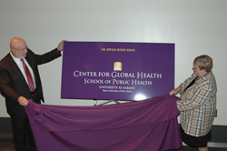 UAlbany School of Public Health Dean Philip Nasca and Center for Global Health Director Carol Whittaker unveil the banner for the new center devoted to addressing the world's health issues.