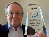 CEHC Professor David Turetsky holds up his Information Sharing Hall of Fame trophy.