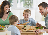 Family sits around the dinner table.