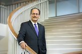 President Rodriguez on stairs in the Campus Center.