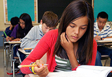 Middle school students pore over an exam.