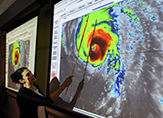DAES Associate Professor Kristen Corbosiero points to satellite infrared image of Hurricane Florence. (Photo courtesy of Will Waldron/Times Union)