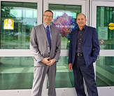 Lednev and Wickenheiser stand together in front of The RNA Institute.