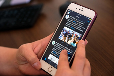 CEHC Assistant Professor Amber Silver scrolls through Hurricane Florence Twitter hashtags.