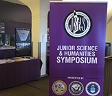 Junior Science & Humanities Symposium signage on campus.