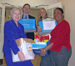 Volunteers carrying boxes of food.