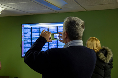 Rick Karlin of the Times Union takes a photo of the NYS Mesonet's station monitor feeds at Tuesday's open house.