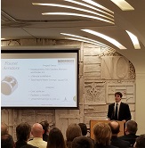 student at podium presenting strategies with power-point 