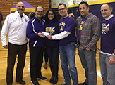 Donors present $50,000 check for Scott M. McGovern Scholarship at the Big Purple Growl.