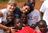 Third World Impact volunteers Natalie Wallace and Nishtha Modi of UAlbany with children in Uganda.